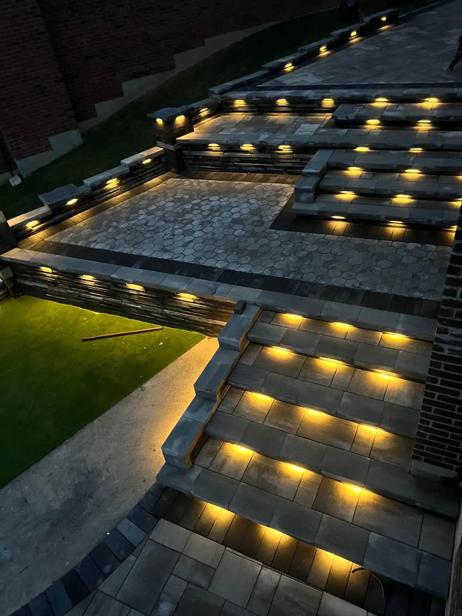 Illuminated natural stone steps with LED riser lighting at night