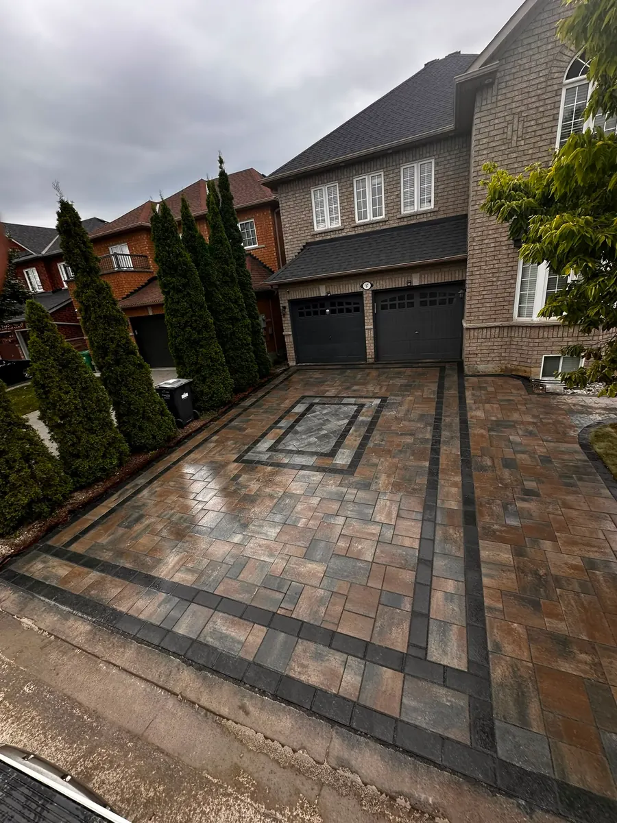 Brick-pattern paver driveway with a dark contrasting border
