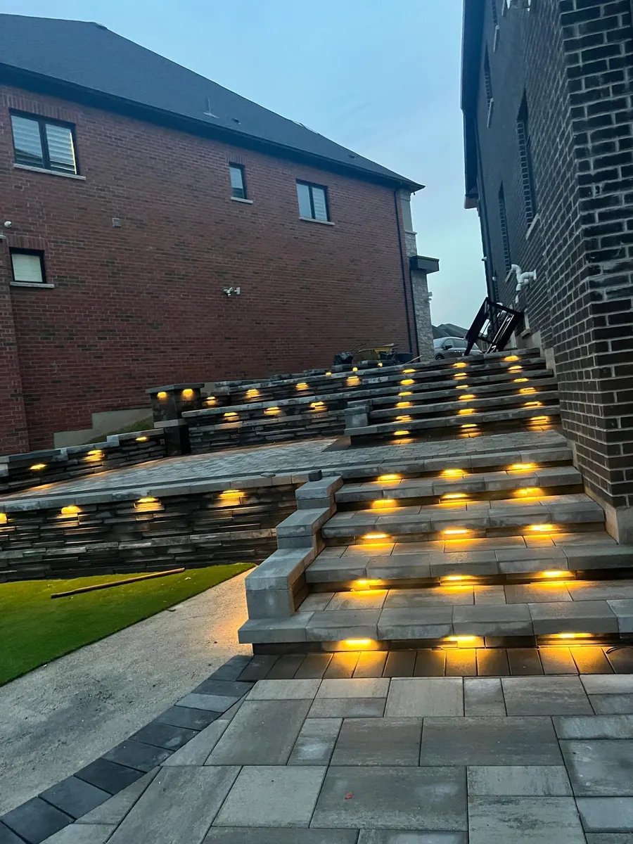 Tiered stone landscape steps with warm lighting at dusk