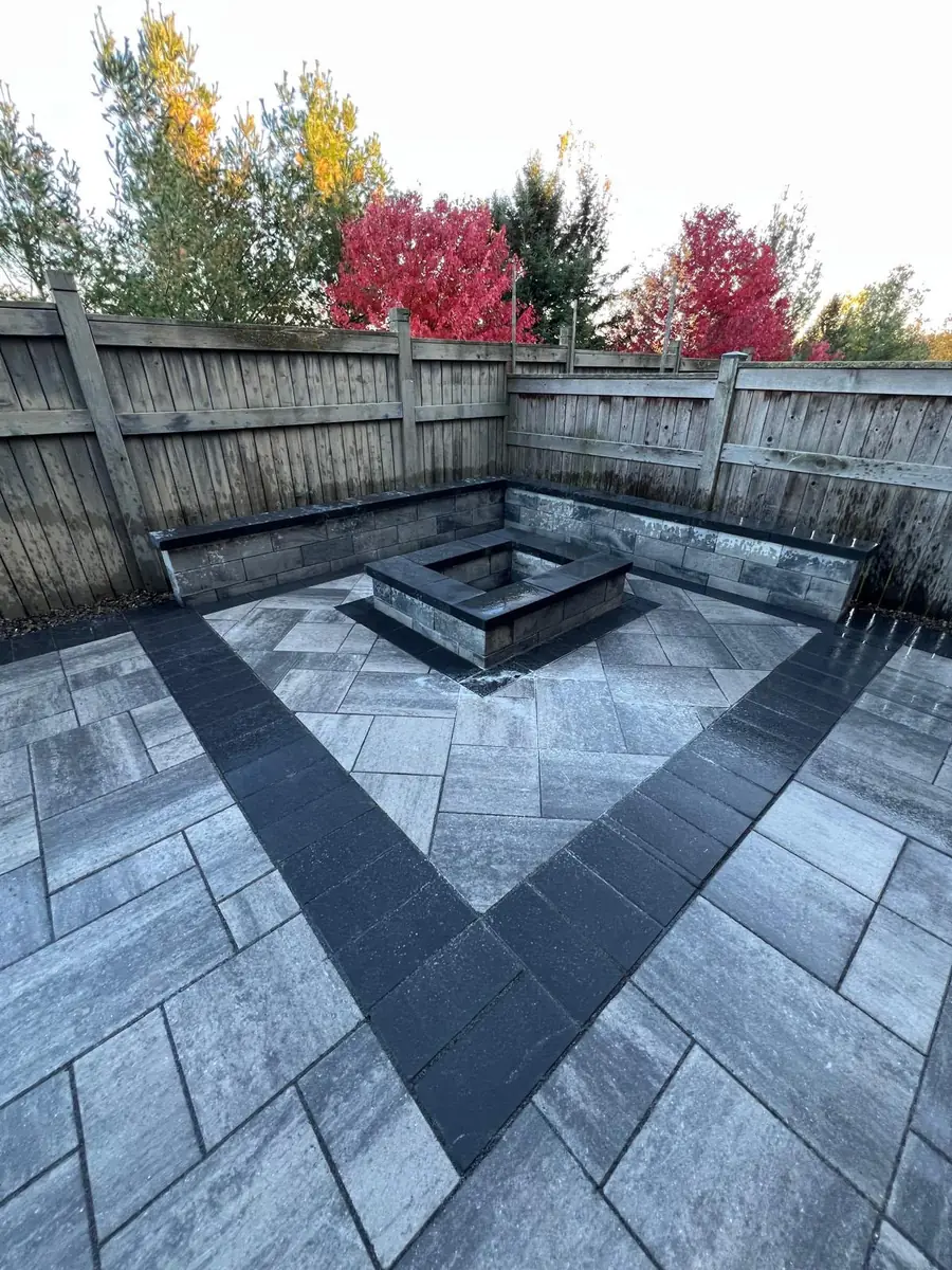 Stacked-stone seat wall and fire pit with autumn foliage