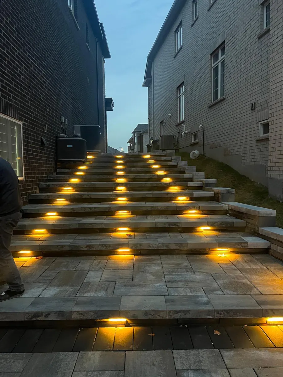 Illuminated paver steps glowing amber at dusk
